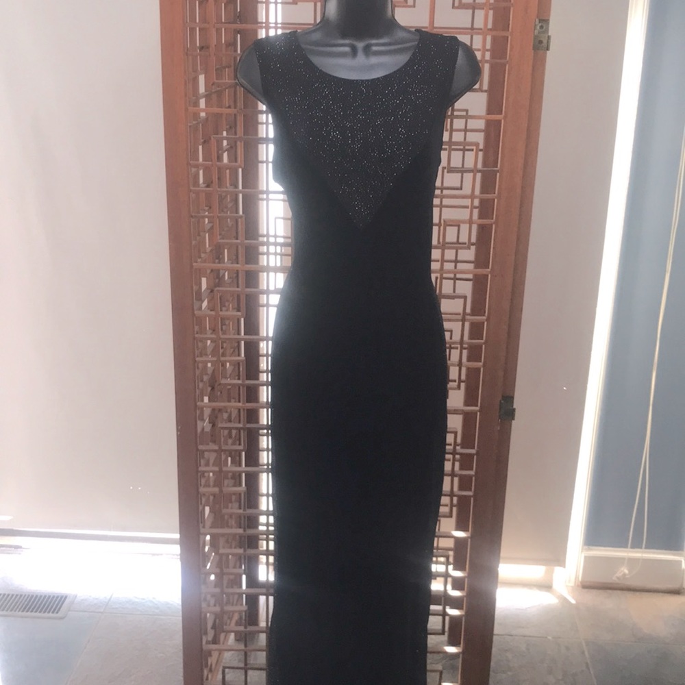 Maxima floor length black dress with shimmer ion the neckline and both sides.